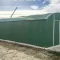 Groene varianthal van 7,8 meter breed als tijdelijke werkplaats of opslagruimte op een bouwlocatie.