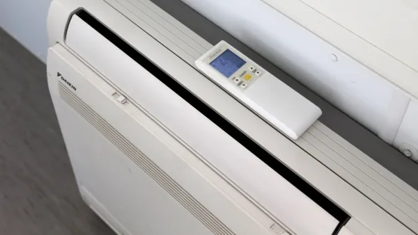 Airconditioning met afstandsbediening in sanitairunit met 2 douches en 2 toiletten.