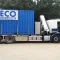 Blauwe FSA container van RECO op een vrachtwagen tijdens transport.